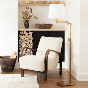 accent chair with white cushions next to brass floor lamp
