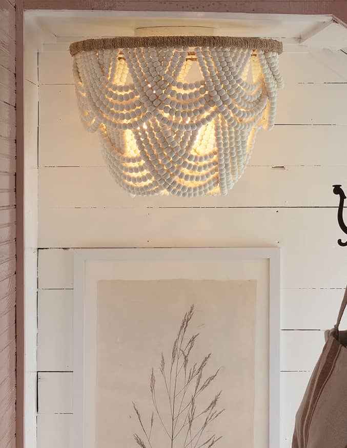 white beaded flush mount above picture of leaf