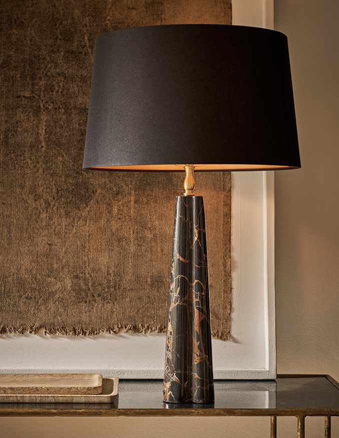 White table lamp on a wooden console table near a window