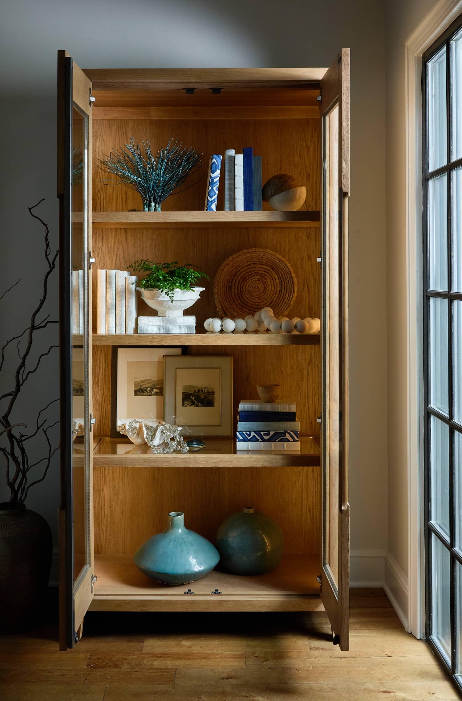 Wood shelf with clams blue and white books and picture frames