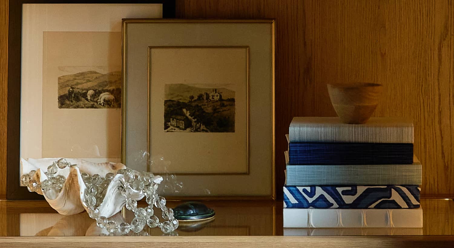 Shelf with blue and white books and a clam bowl