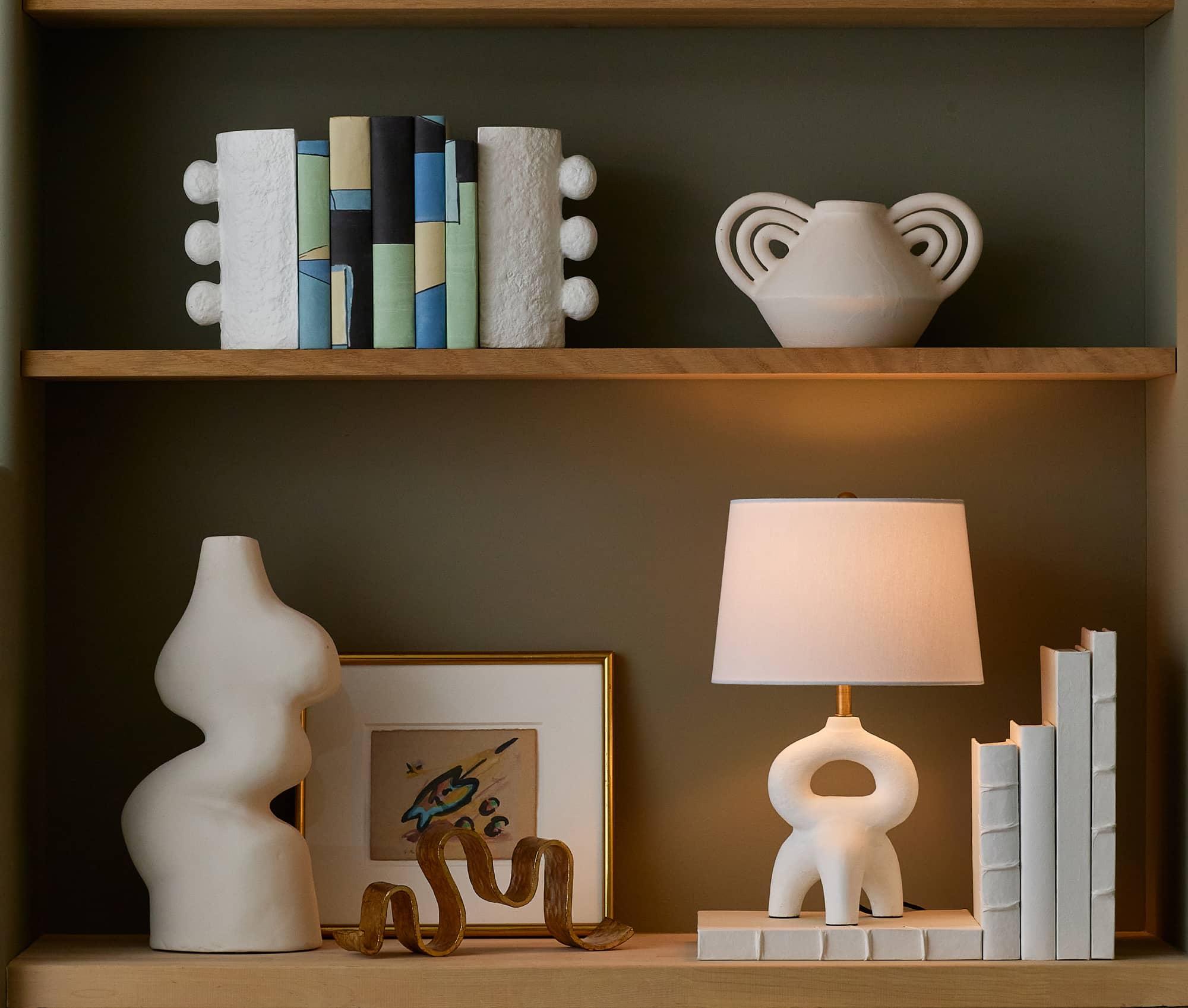 Built in shelves with vases lamps books and picture frames