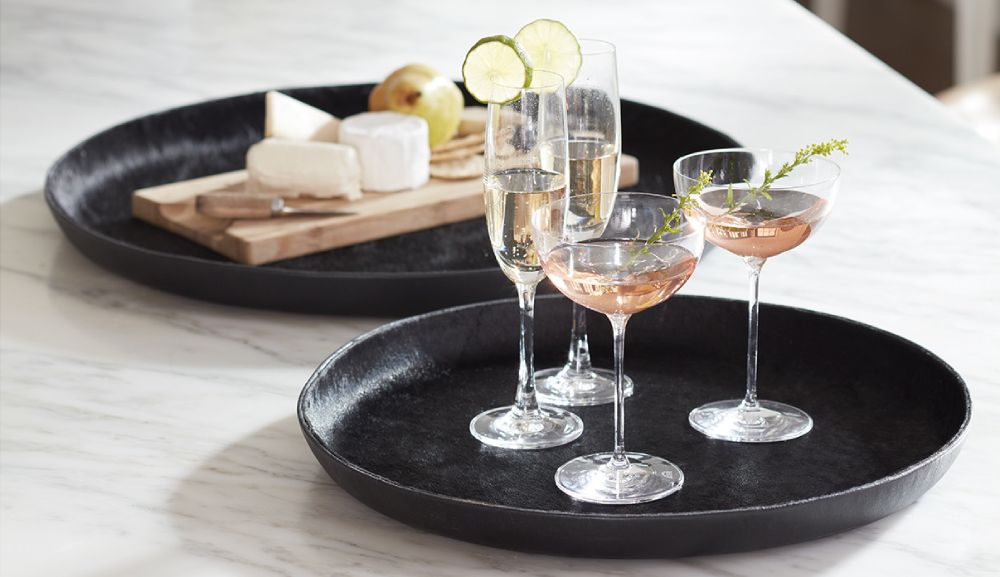 A modern marble kitchen counter with two leather serving trays