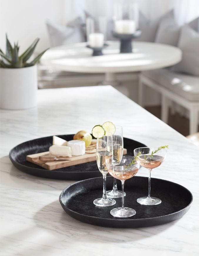 A modern marble kitchen counter with two leather serving trays