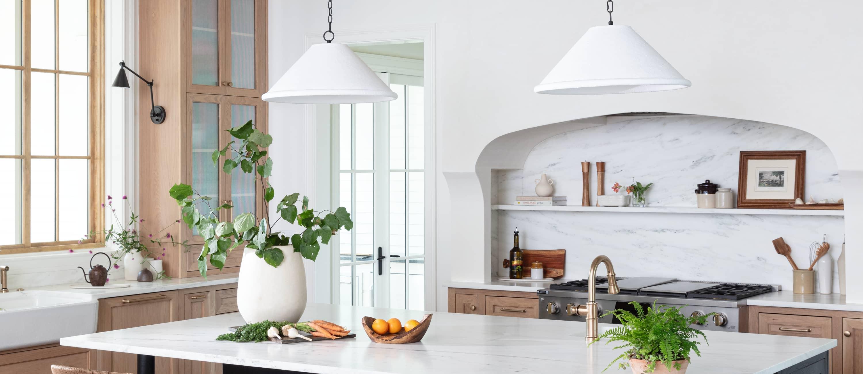 kitchen with white marble island and inset stove with shelves