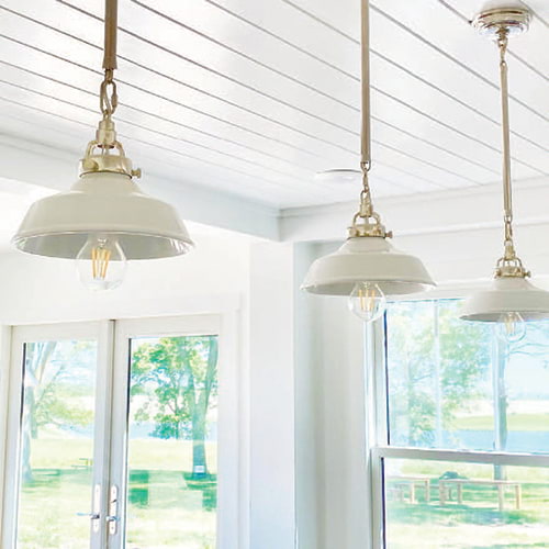 Coastal styled pendants hung from a sun room porch ceiling