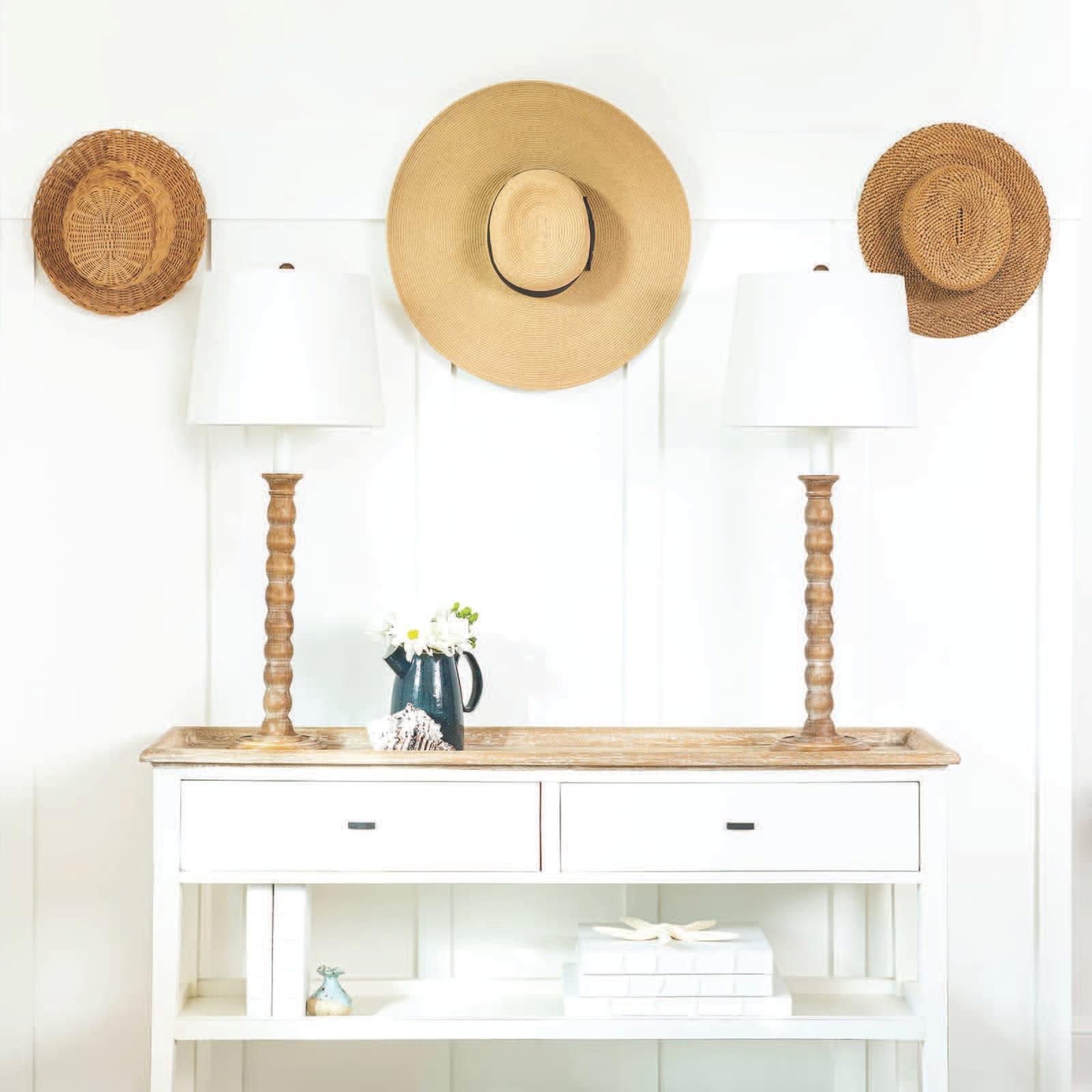 A wood console table with two beautiful natural wooden lamps with white shades