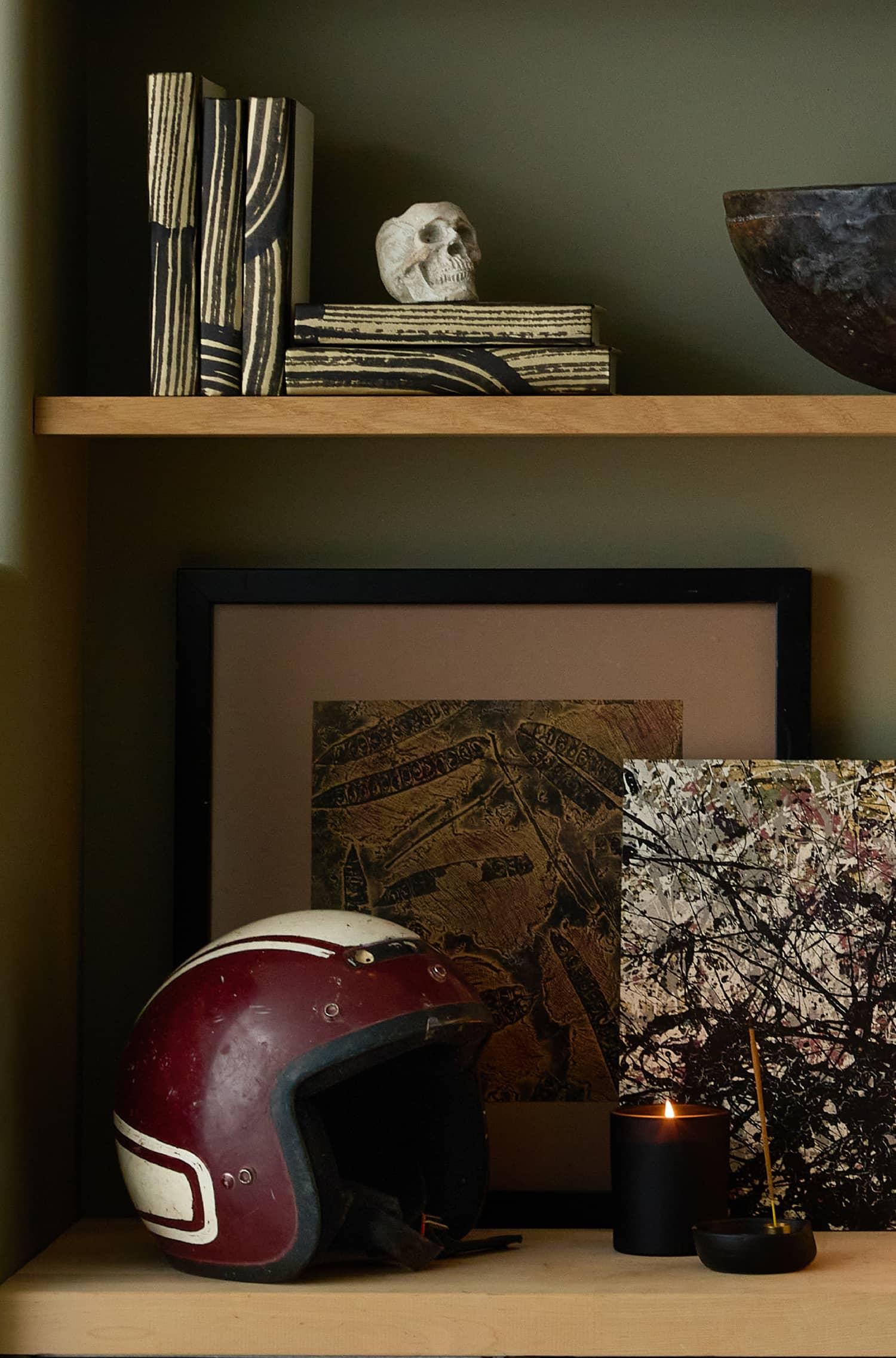 Built in shelves with books lamps and an old football helmet