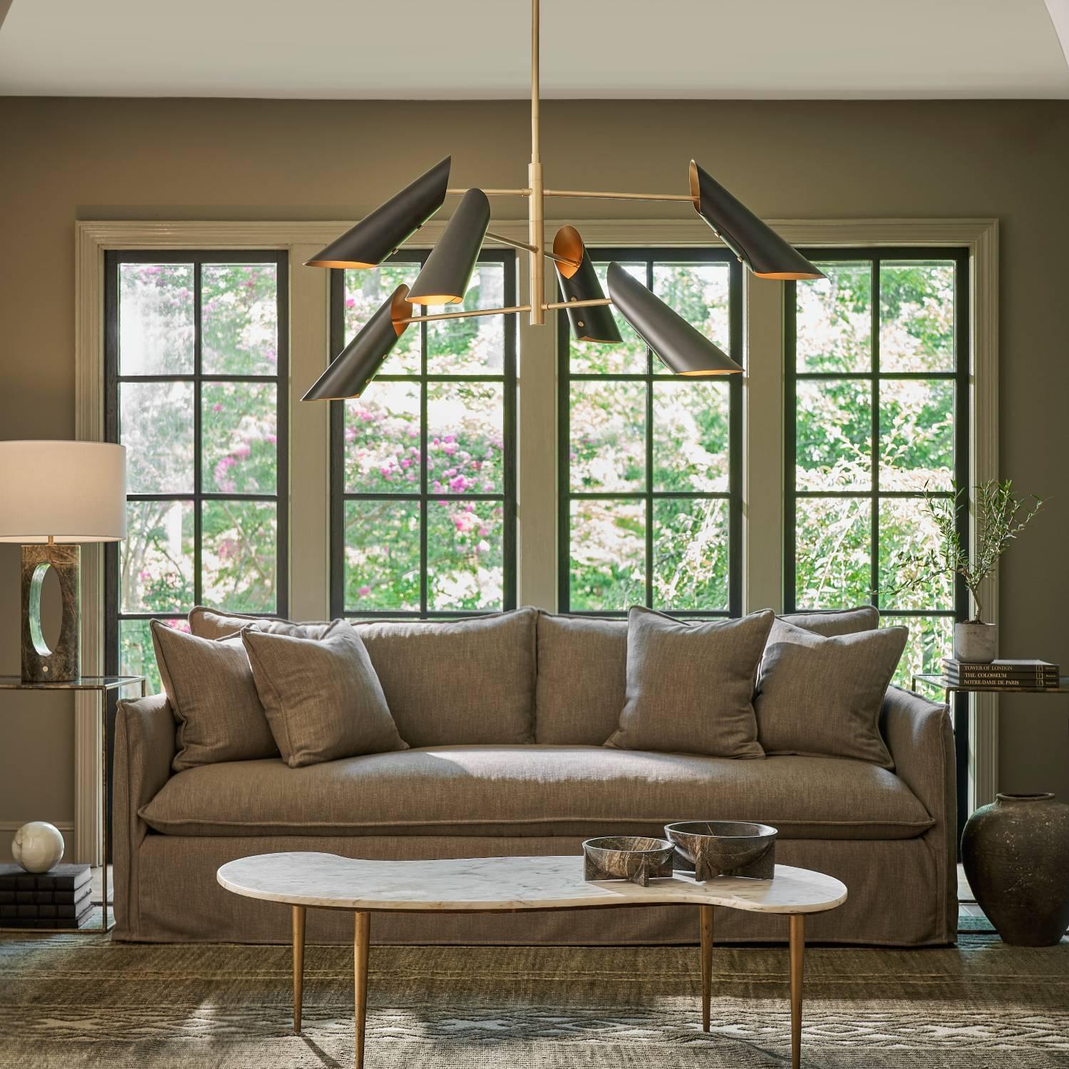 living room with sofa coffee table and chandelier