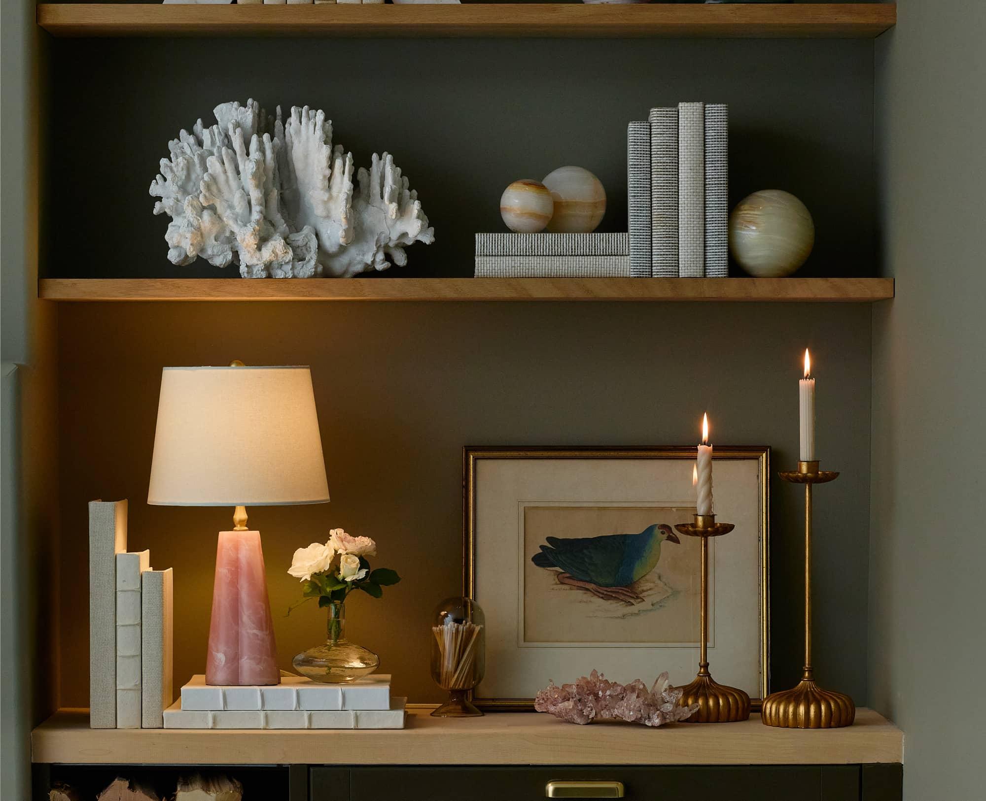 Built in shelves with lamps candle holders books and picture frames