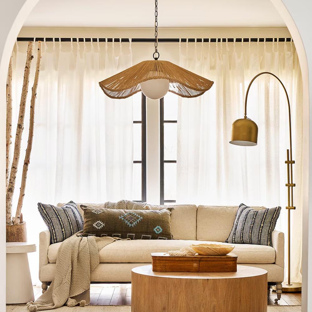 living room with a white couch and circular wood coffee table