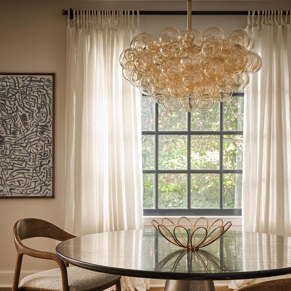 Dining room with a circular table and bubble chandelier