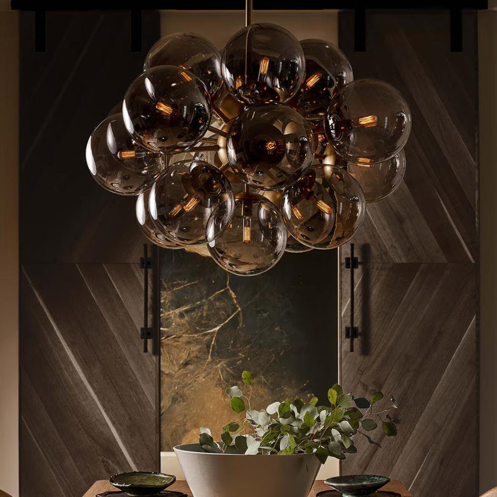smoky glass chandelier above a dining table