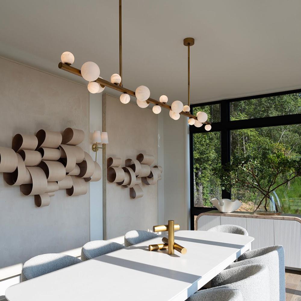 dining room with long white oval table and linear chandelier