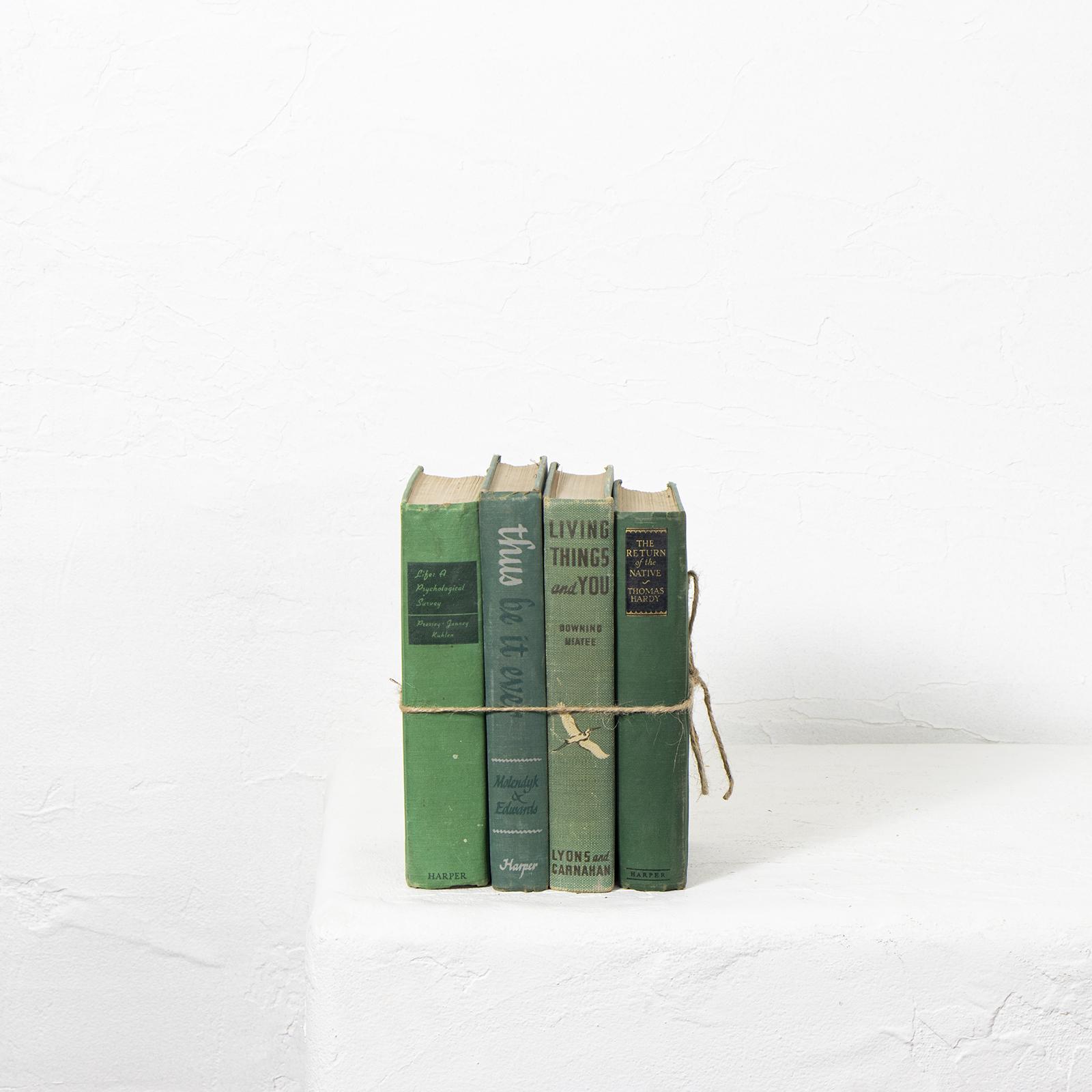 Vintage green books tied together with string