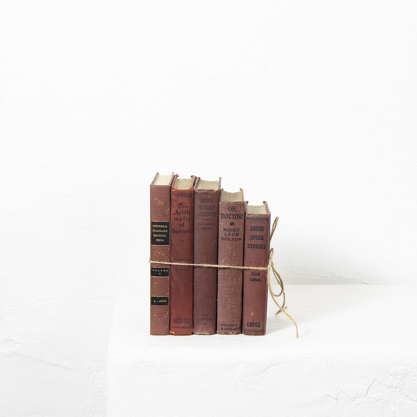 Vintage red books tied together with string
